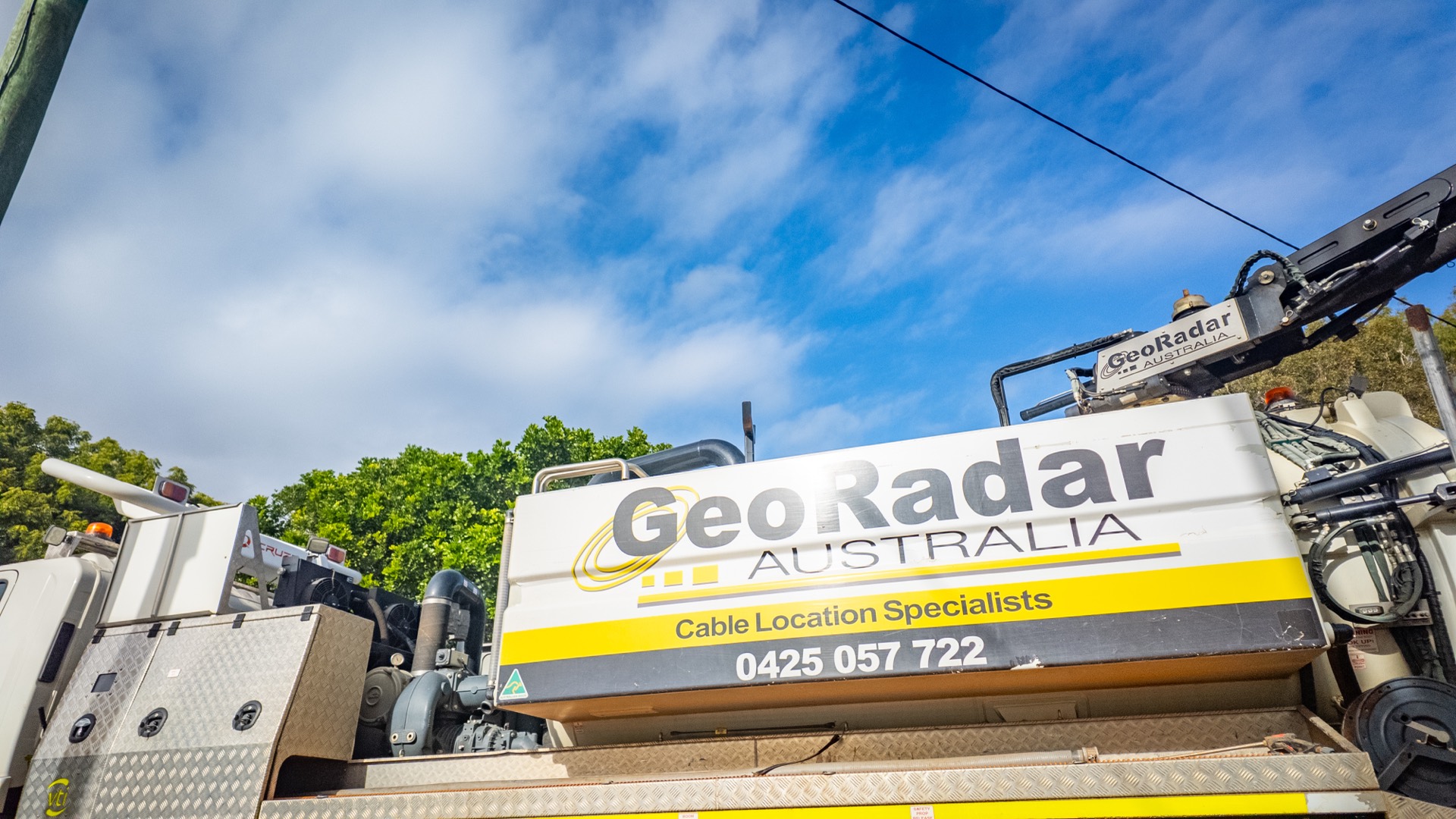 A GeoRadar vacuum excavation truck with boom raised, ready to work